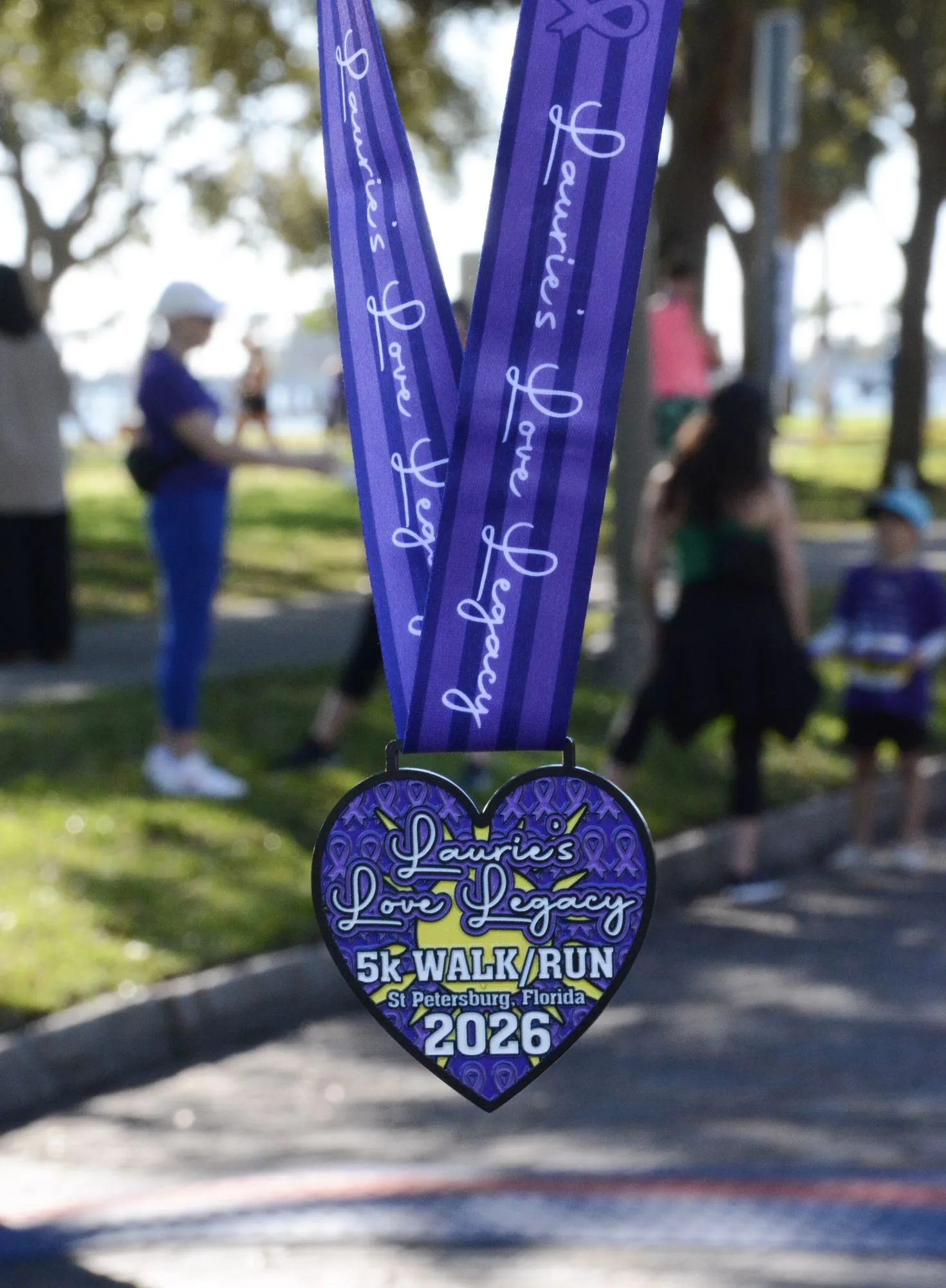 Heart-shaped 2026 Legacy Run finisher medals on purple ribbons